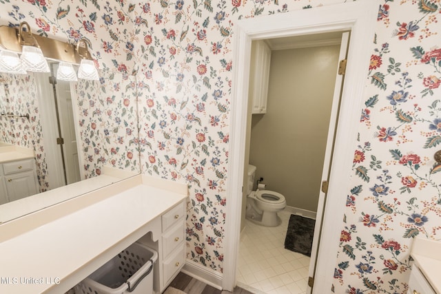 bathroom featuring vanity, toilet, and tile patterned floors