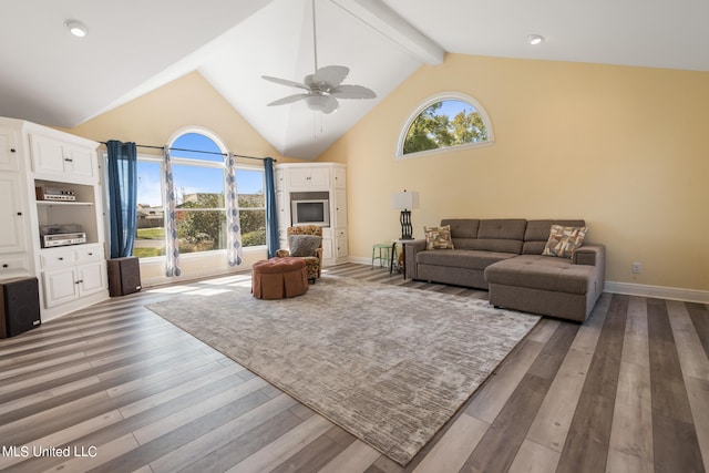 living room featuring beamed ceiling, high vaulted ceiling, dark wood-type flooring, and ceiling fan