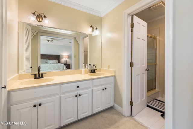 bathroom with vanity, ornamental molding, and an enclosed shower