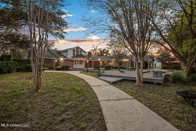 surrounding community with a yard and a deck