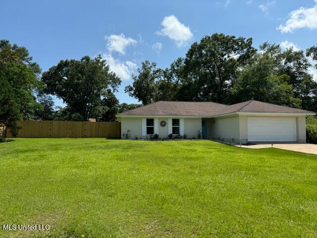 single story home featuring a garage and a front lawn