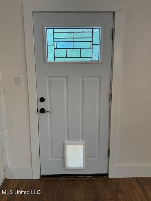 doorway with dark hardwood / wood-style flooring