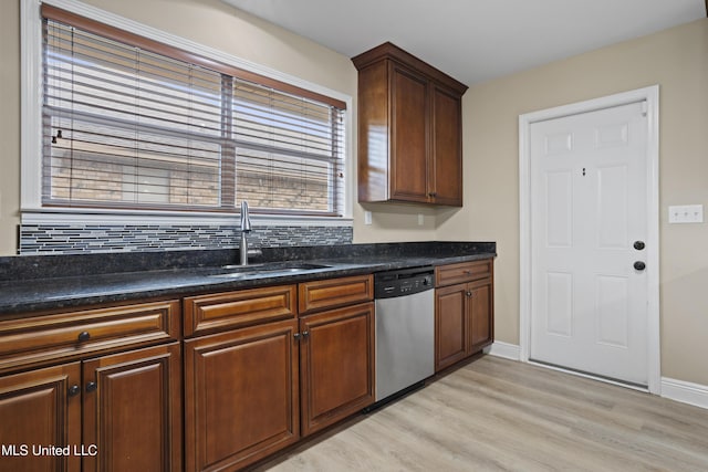 13239 Tyler Ln, Gulfport, MS 39503 - kitchen featuring dishwasher, a sink, light wood-type flooring, backsplash, and baseboards