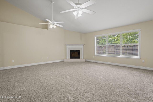 13239 Tyler Ln, Gulfport, MS 39503 - unfurnished living room featuring a fireplace with raised hearth, carpet, baseboards, ceiling fan, and high vaulted ceiling