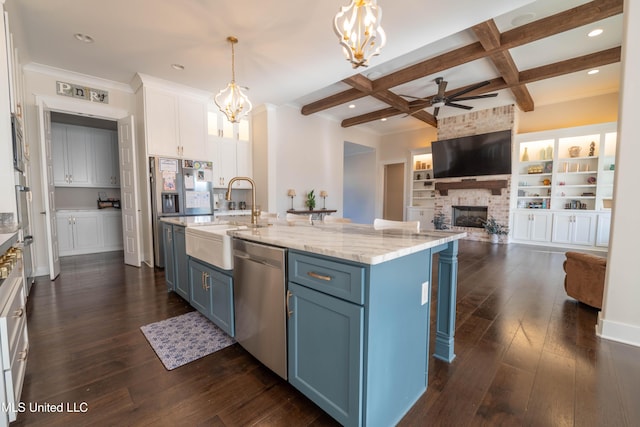 kitchen featuring blue cabinetry, white cabinetry, beam ceiling, pendant lighting, and stainless steel appliances