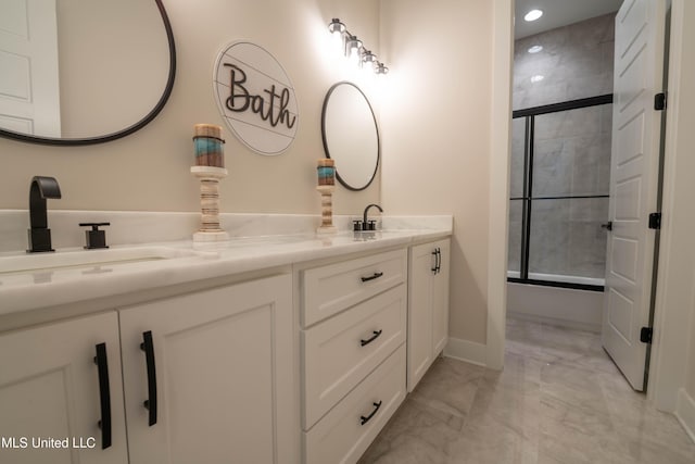 bathroom featuring vanity and combined bath / shower with glass door