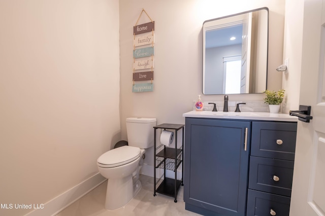 bathroom with vanity, toilet, and tile patterned flooring