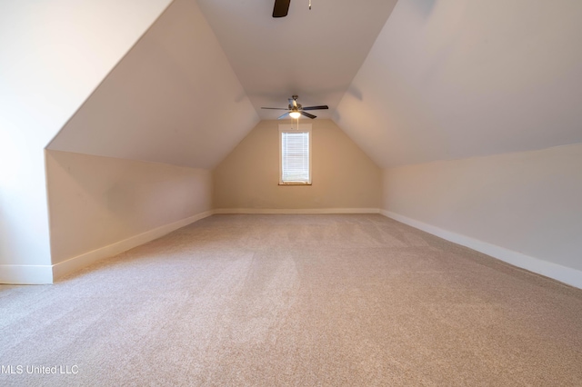 additional living space featuring light carpet, ceiling fan, and lofted ceiling