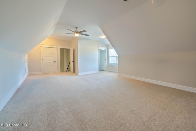 bonus room with ceiling fan, light colored carpet, and lofted ceiling