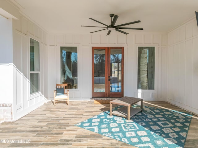 sunroom / solarium featuring ceiling fan and french doors