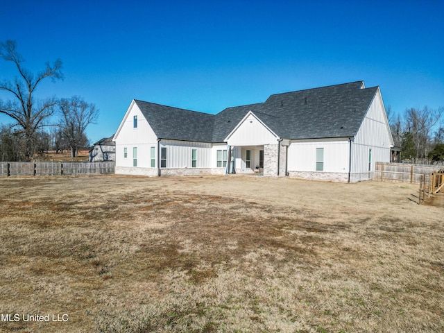 rear view of house featuring a yard