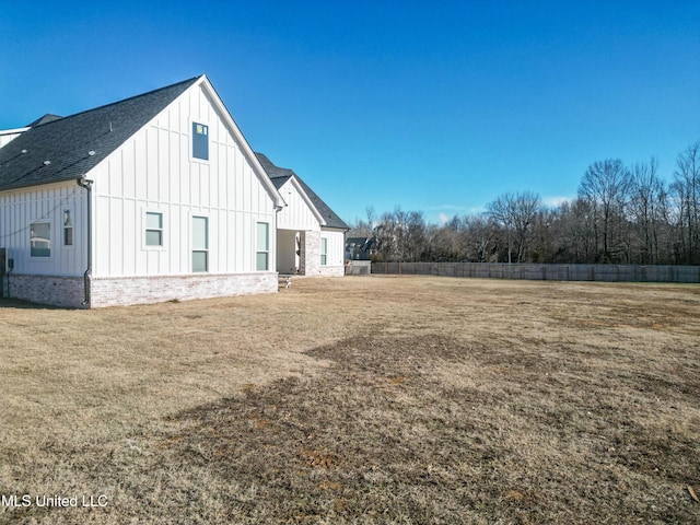 view of side of home featuring a lawn