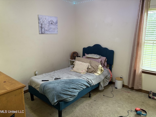 bedroom with baseboards, carpet flooring, and multiple windows