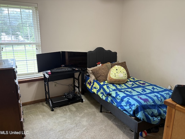 carpeted bedroom featuring multiple windows