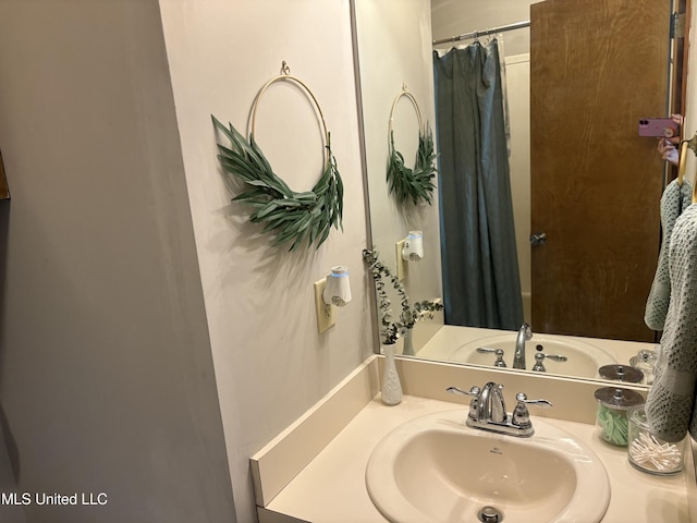 bathroom featuring vanity and a shower with shower curtain