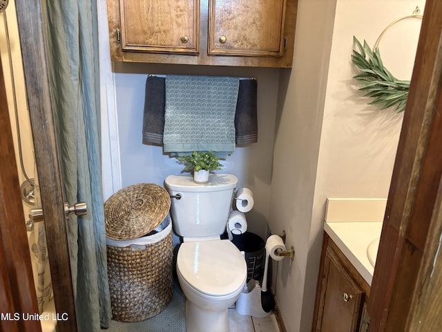 full bathroom featuring vanity, tile patterned flooring, and toilet