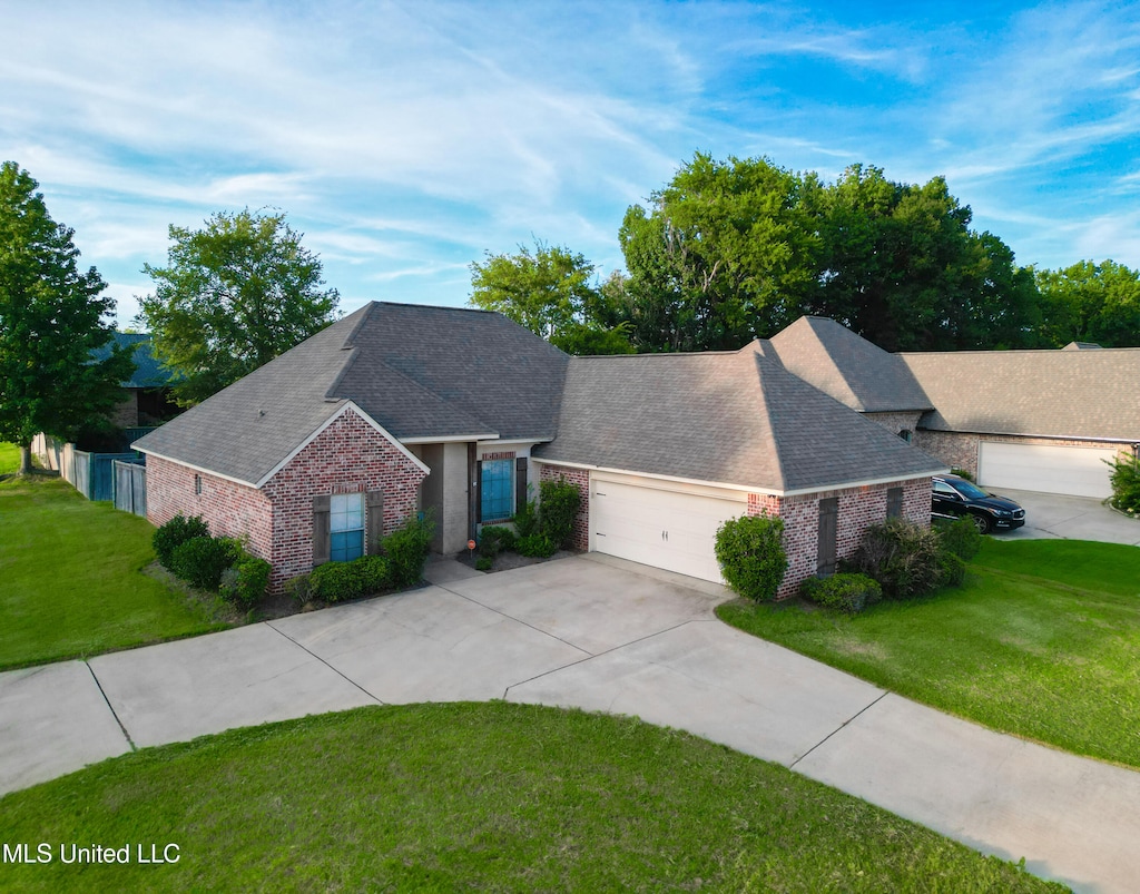 view of front of property featuring a garage and a front lawn