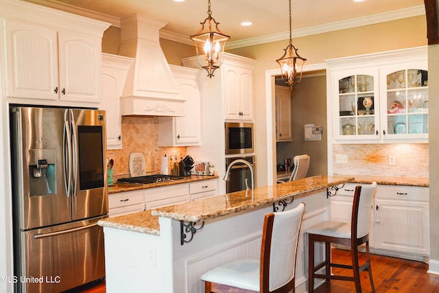 kitchen with white cabinetry, a center island, dark hardwood / wood-style floors, pendant lighting, and appliances with stainless steel finishes