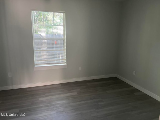 empty room featuring dark hardwood / wood-style flooring