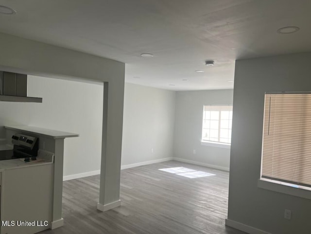 unfurnished living room with wood-type flooring and washer / clothes dryer