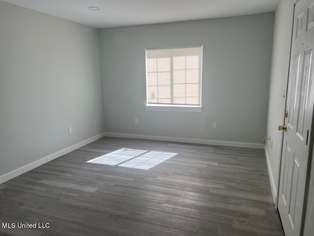 empty room with dark hardwood / wood-style floors