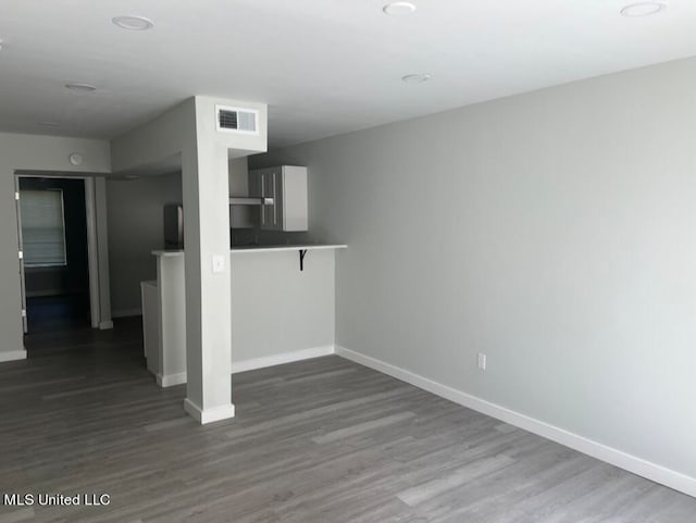 unfurnished room with hardwood / wood-style floors