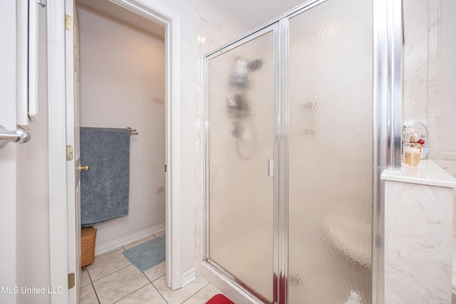 bathroom featuring an enclosed shower and tile patterned flooring