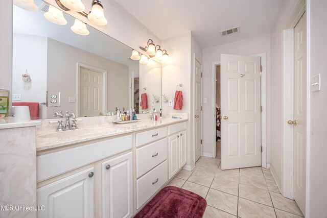 bathroom with vanity and tile patterned floors