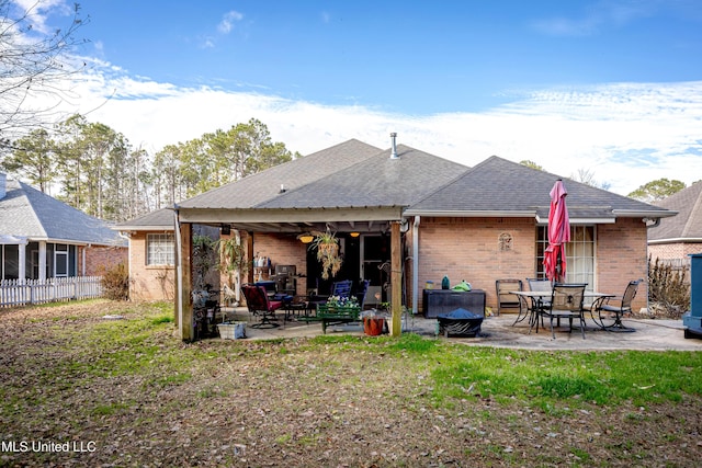 back of property with a patio and a lawn