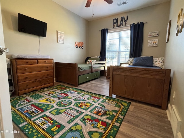 bedroom with wood-type flooring and ceiling fan