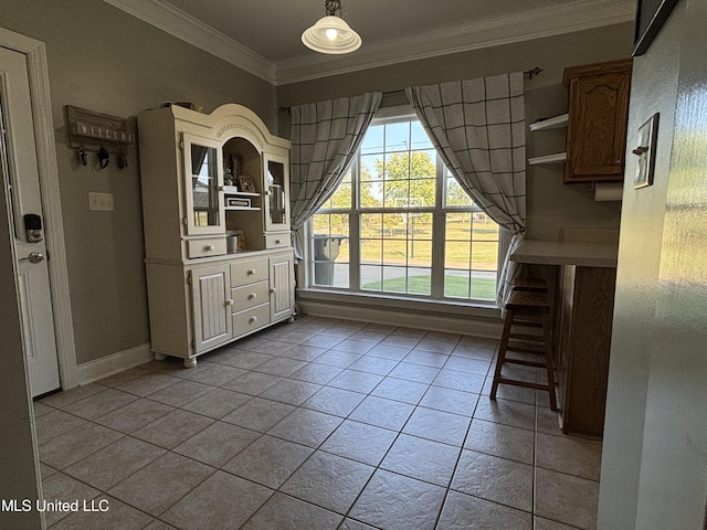 unfurnished dining area with ornamental molding and light tile patterned floors