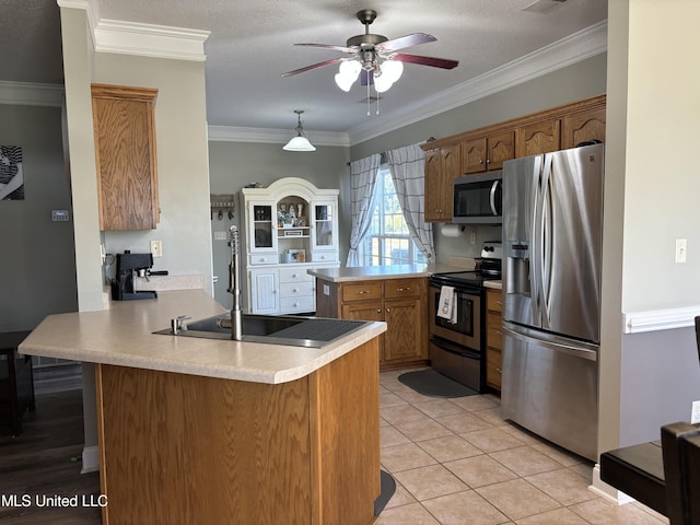 kitchen featuring kitchen peninsula, ornamental molding, stainless steel appliances, and a textured ceiling