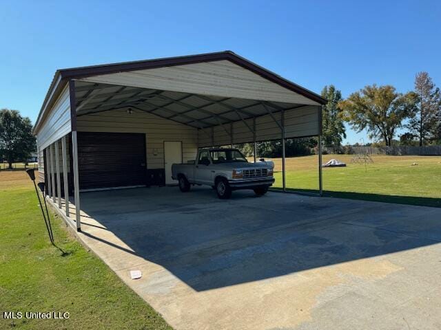 view of parking / parking lot with a yard and a carport