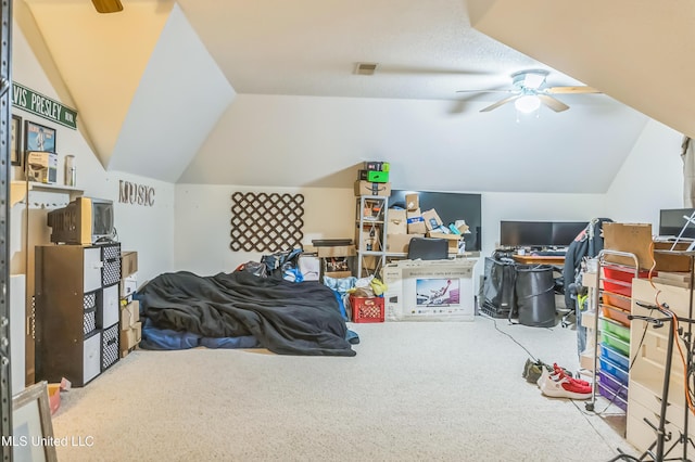 carpeted bedroom with vaulted ceiling and a ceiling fan