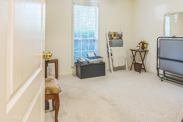 sitting room featuring carpet and baseboards
