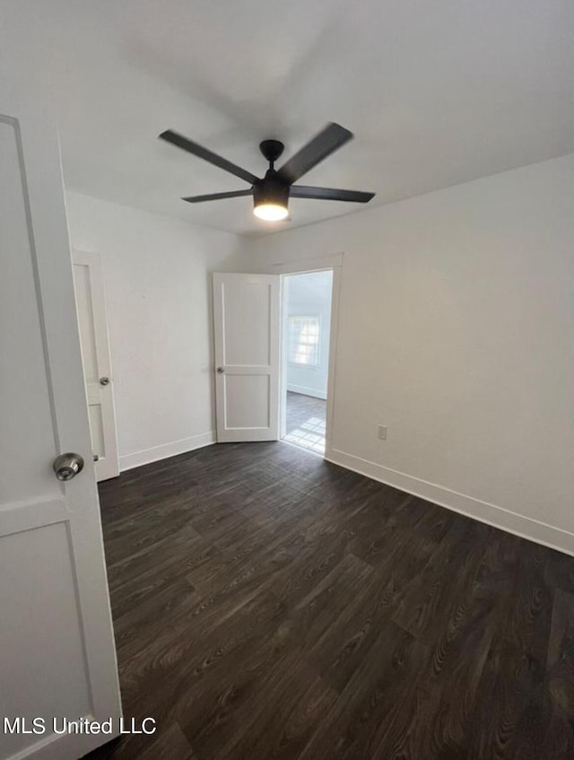 unfurnished room featuring ceiling fan and dark hardwood / wood-style floors