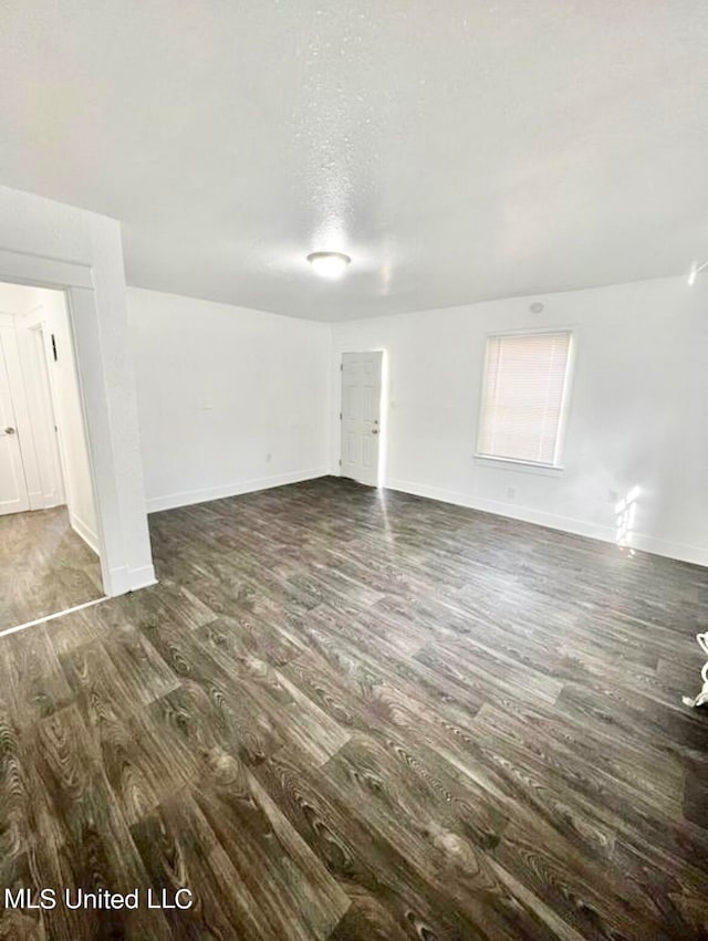 empty room featuring dark wood-type flooring