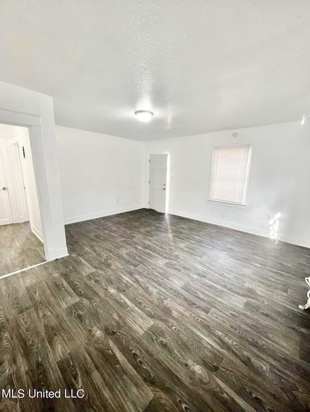 128 Carolyn Ave, Jackson, MS 39209 - unfurnished living room featuring wood finished floors and baseboards