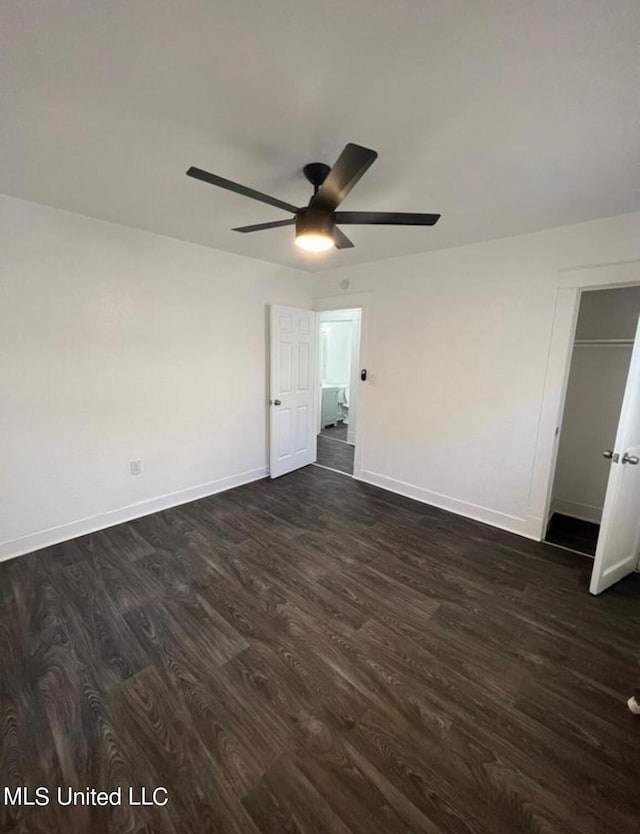 unfurnished bedroom with dark wood-type flooring, ceiling fan, and a closet