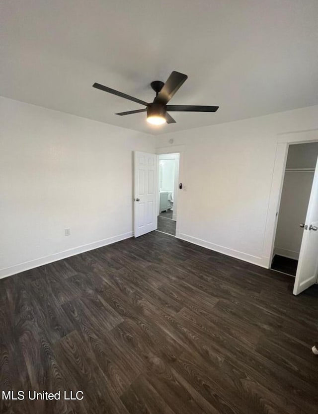 128 Carolyn Ave, Jackson, MS 39209 - unfurnished bedroom with dark wood-style floors, baseboards, and ceiling fan