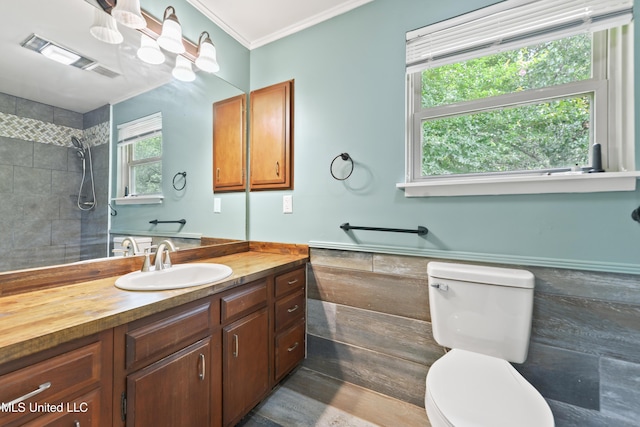 120 Clower Ave, Long Beach, MS 39560 - bathroom with crown molding, vanity, tiled shower, a wainscoted wall, and tile walls