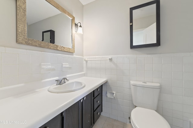 120 Clower Ave, Long Beach, MS 39560 - bathroom featuring tile walls, vanity, wainscoting, and tile patterned flooring