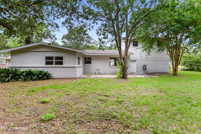 120 Clower Ave, Long Beach, MS 39560 - view of front facade with brick siding, a front lawn, a chimney, and a patio