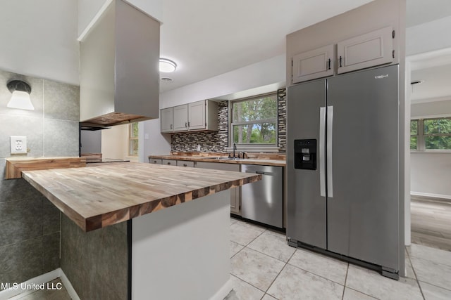 120 Clower Ave, Long Beach, MS 39560 - kitchen featuring appliances with stainless steel finishes, wood counters, healthy amount of natural light, and tasteful backsplash