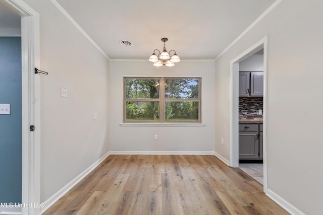 120 Clower Ave, Long Beach, MS 39560 - unfurnished dining area with a chandelier, ornamental molding, and light wood-style floors