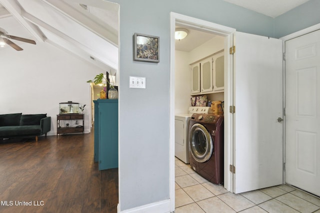 washroom featuring washer and dryer, ceiling fan, light tile patterned floors, and cabinet space