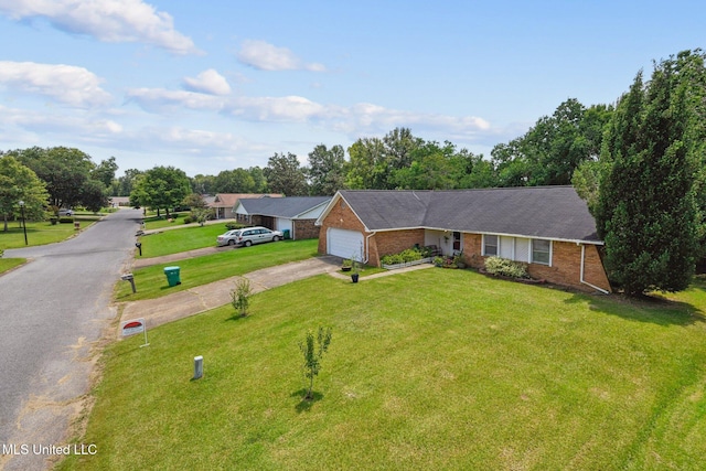 single story home featuring brick siding, an attached garage, driveway, and a front lawn