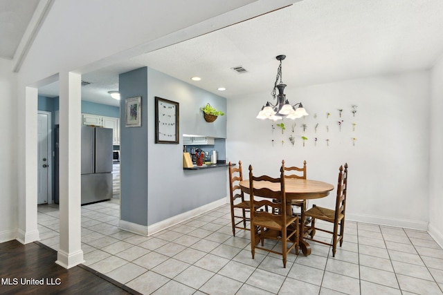 dining room with baseboards, visible vents, recessed lighting, and a chandelier