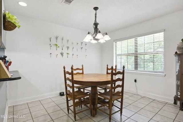 dining space with baseboards, an inviting chandelier, light tile patterned floors, and visible vents