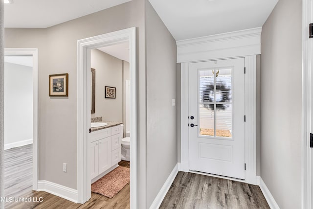 entryway featuring sink and light hardwood / wood-style floors